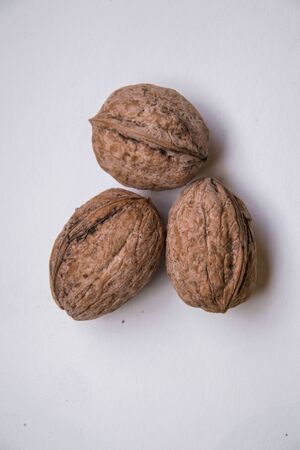 Three dry walnuts on white background, isolated food concept, shellの写真素材