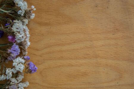 Multicolored dried flowers on wooden background, colorful limonium statice plant with copy space, place for textの写真素材