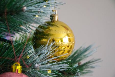 Christmas decoration, xmas toys on the pine tree, holiday concept with shiny balls and pine branchesの写真素材