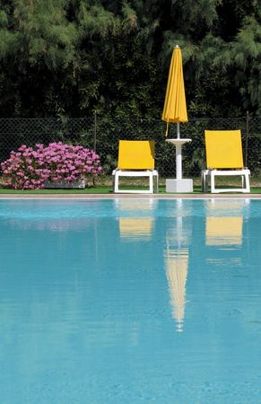 Poolside: Deck chairs and beach umbrellaの写真素材