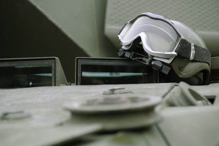 Military helmet and protection glasses on a tankの写真素材