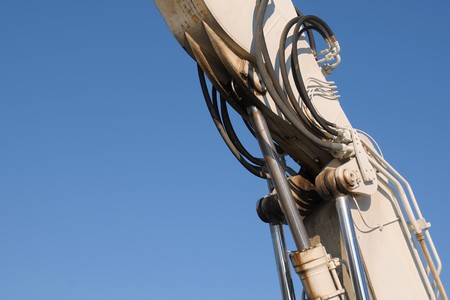 Detail of a jib coupling of a bulldozer on blue skyの写真素材