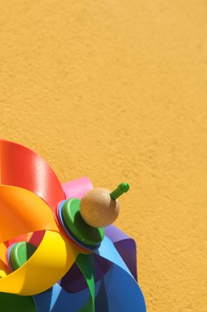 Childhood background: Colored windmill on yellowの写真素材