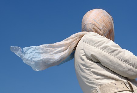 Unrecognizable female with spring dresses during a blowy day