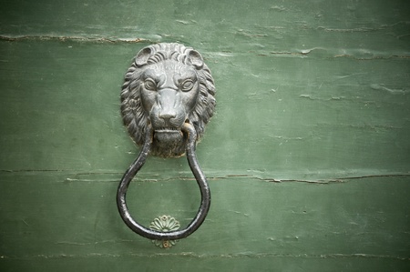 Lion shape handle on an old doorの写真素材