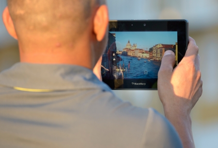 Venice, Italy - June 16, 2012: Tourist taking a picture of Grand Canal with his Blackberry Playbook tablet. BlackBerry is a line of smartphones and tablets developed by RIM (Research In Motion Limited). Shot in Venice, Italy.のeditorial素材