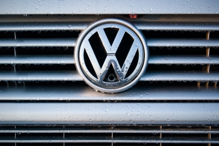 Padua, Italy - July 6, 2011: Wet Volkswagen metallic logo on a car hood. Volkswagen is a German motor vehicles manufacturer. Shot in a public parking in Padua, Italy.のeditorial素材