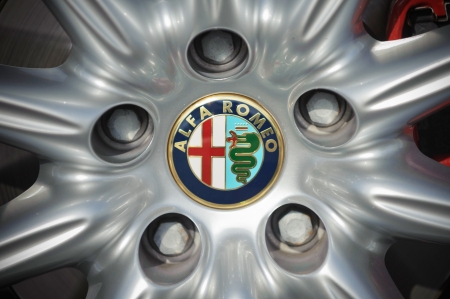 Padua, Italy - April 25, 2012: Circle shape Alfa Romeo logo on an alloy wheel of an Alfa Romeo car. Alfa Romeo is an Italian cars manufacturer. Shot in a public parking in Padua, Italy.のeditorial素材