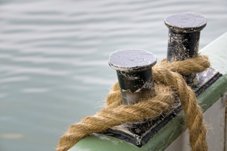 Rope fastened on a metallic onboard bollard along a ferry broadsideの写真素材