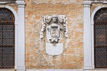  Venice, Italy  Ancient spooky relief on a church wallの写真素材