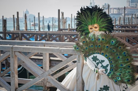 Venice, Italy - February 17, 2012: Mask posing along Saint Mark waterfront during famous Venetian Carnival celebrations. Shot in Venice, Italyのeditorial素材