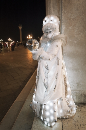 Venice, Italy - February 17, 2012: Mask posing at dusk in Saint Mark square during famous Venetian Carnival celebrations. Shot in Venice, Italyのeditorial素材