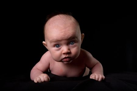 Baby Lying Down on Black Facing You