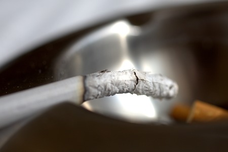 Bad addiction. Ashtray and cigarettes close-up.