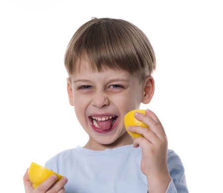 boy eating lemonの写真素材