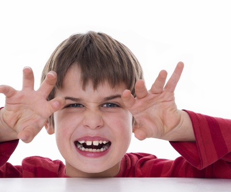 a boy trying to scare someone の写真素材