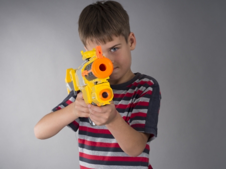 boy with toy gunの写真素材