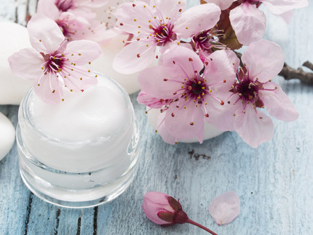 natural facial cream with spring flowers decorationの写真素材