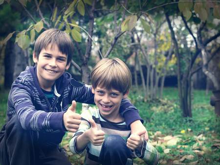 two brothers playing in the parkの写真素材