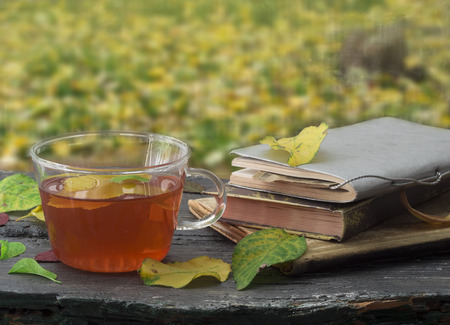 cup of tea with autumn leavesの写真素材