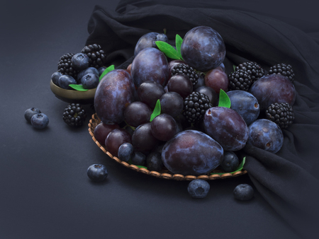 blue fruit on the table in the antique arrangementの写真素材