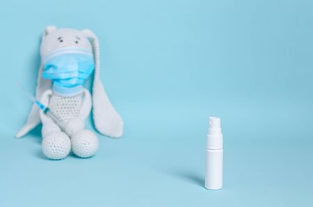 White spray can for antiseptic, disinfectant in the form of a spray on a blue background....