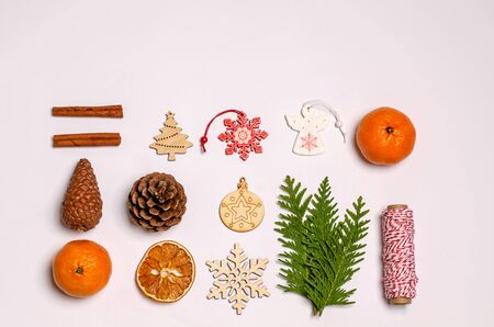 White Christmas or New Year background with juniper branch, cinnamon, anise, gift box, dry oranges,...