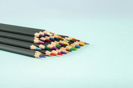 Color pencils on a blue background. A set of pencils for drawing, creativity, hobbies, classes. Flat lay, copy space, space for tex. Close-up.の写真素材