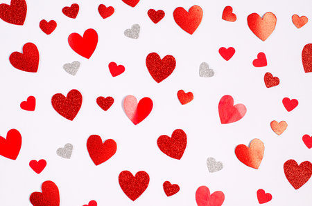 Decorative clothespins with red hearts hang on a clothesline for Valentine's Day on a white background. Space for text, copy space.の写真素材