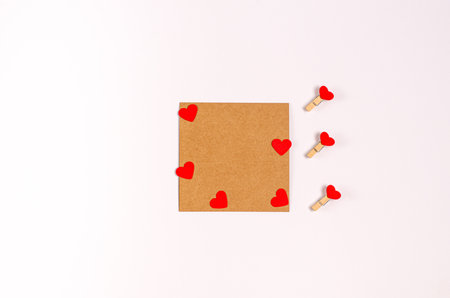 Decorative clothespins with red hearts hang on a clothesline for Valentine's Day on a white background. Space for text, copy space.の写真素材