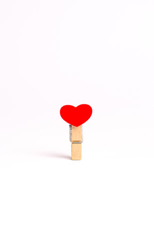 Clothespin with red heart for Valentine's Day on white