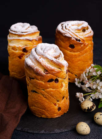 The cake is decorated with white sugar icing and pastry sprinkles on a dark background. Traditional...