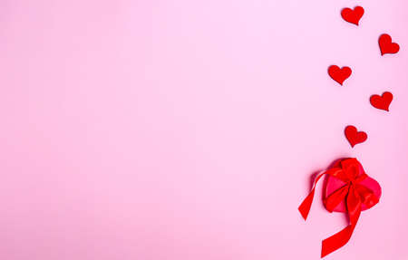 Red heart balloon on a pink background. Love concept, copy space, flat lay, place for text, banner, top view.の写真素材