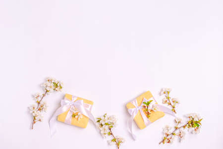 Blossoming cherry branches on a white background. Flat lay, postcard blank, space for text, copy space. View from above.の写真素材