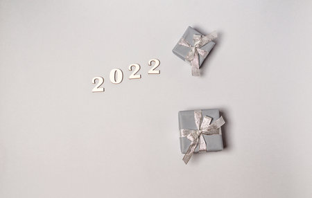 Craft postcard and wooden natural New Year's toys, numbers 2022 on a beige background, copy space....