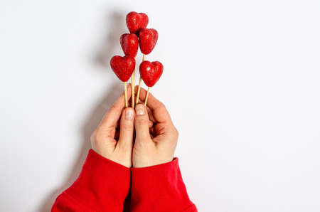 Blank craft postcard for congratulations with a shiny heart on a white background. Love concept, copy space, flat lay, place for text, banner, top view.の写真素材