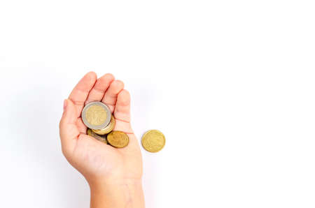 Different coins of cents in children's hands on a white background with space for text. The concept...