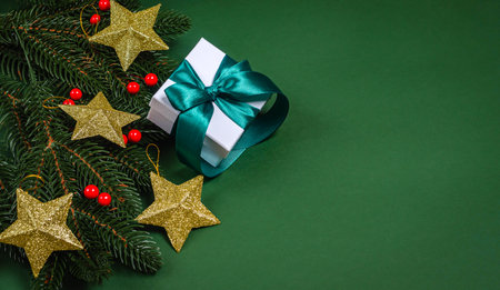 Fir Christmas branches in a female hand on a gray background with a place for text. The concept of New Year and Christmas holidays, congratulations. copyspace. View from aboveの写真素材