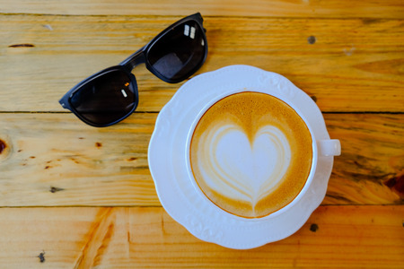 coffee latte art on wood tableの写真素材