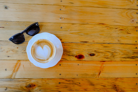 coffee latte art on wood tableの写真素材