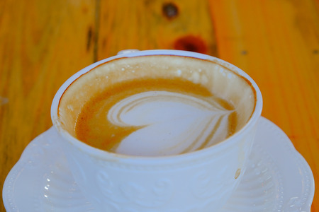 coffee latte art on wood tableの写真素材