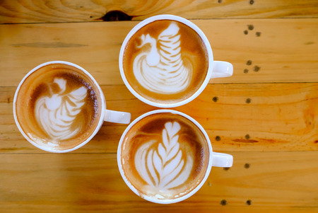 coffee latte art on wood tableの写真素材