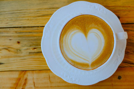 coffee latte art on wood tableの写真素材