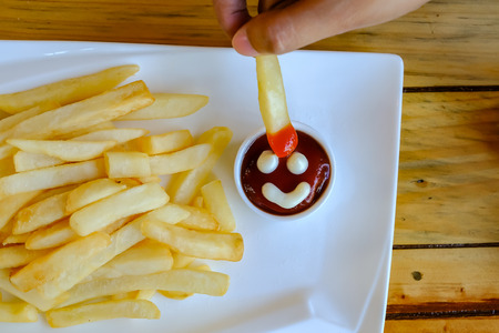 french fried and smile Chicken sauce on handの写真素材