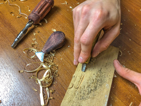 carpenter does his job, wood processing by hand.