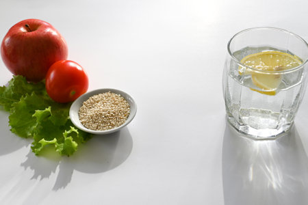 Top view of fresh fruits and vegetables next to phonendoscope on light blue wooden background. concept of health care. balanced diet. copy spaceの写真素材