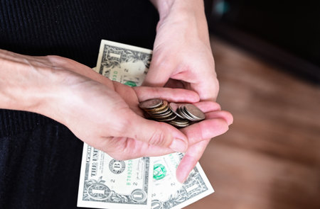 girl holds a wallet in her hands, shopping, dollars in her purse, wallet full of dollarsの写真素材