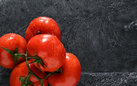 fresh organic cherry tomatoes on a dark backgroundの写真素材