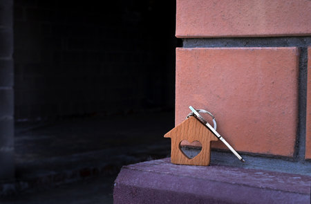 A woman holds the key to a new house in her hand. Mortgage loan approval housing loanの写真素材