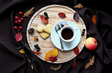 Autumn still life with a cup of coffee, cookies and burgundy leaves